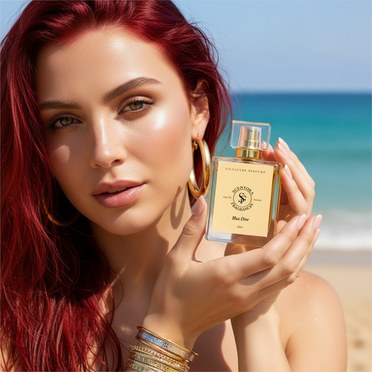Woman with red hair holding Blue Dive 50ml perfume at the beach